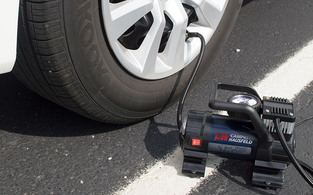 Campbell Hausfeld inflator next to car tire